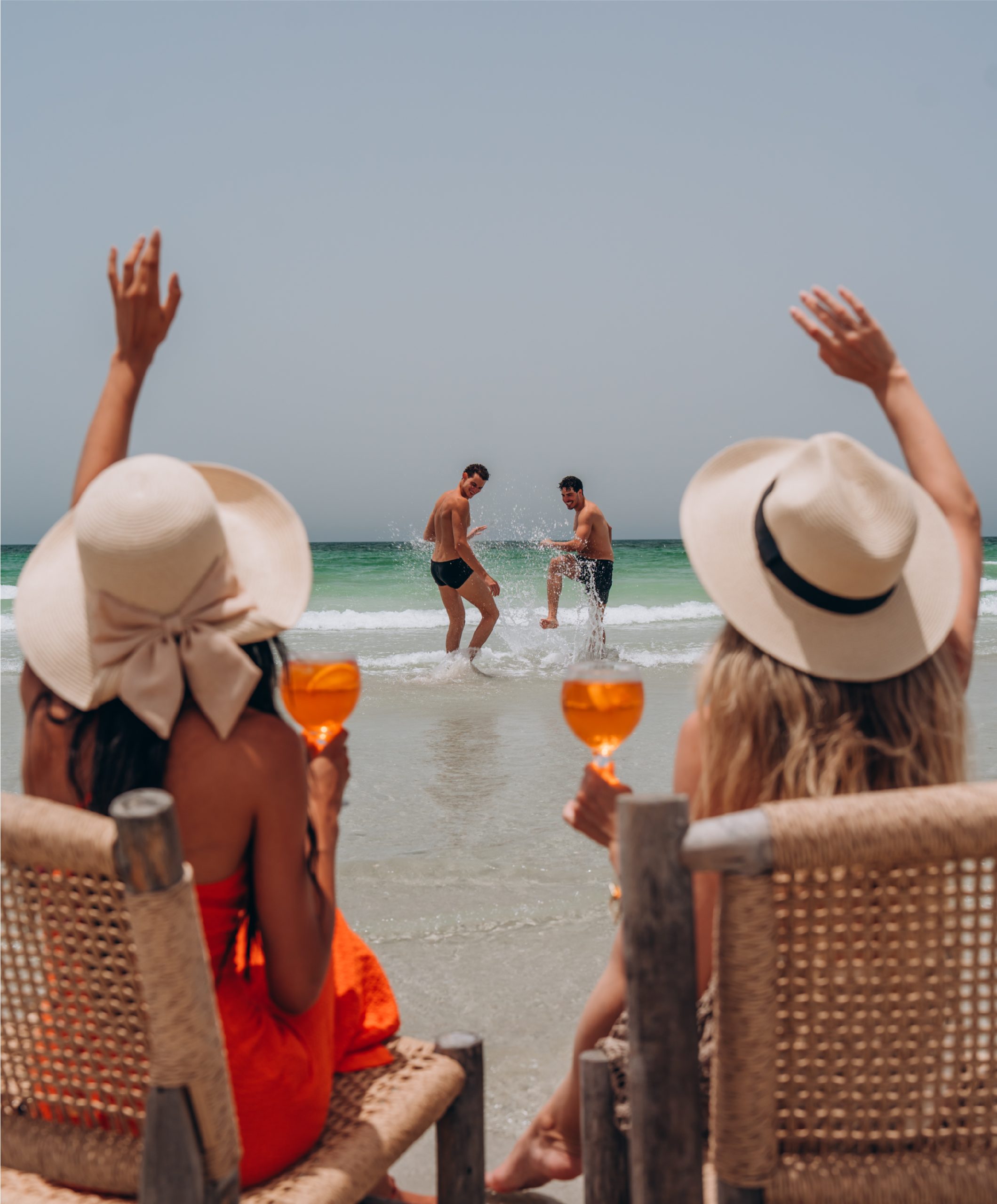 Guests relaxing on the beach beside the sea